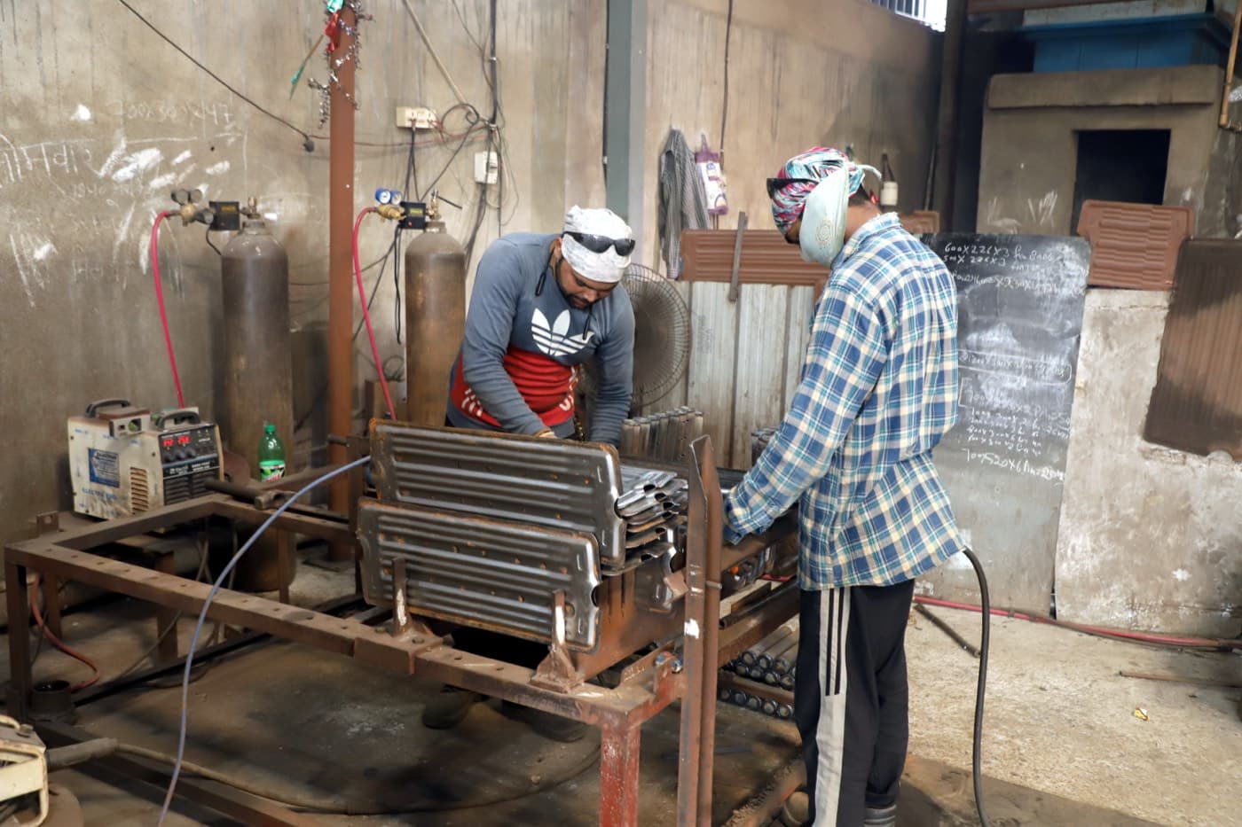 Radiator elements being assembled and fitted with flanges